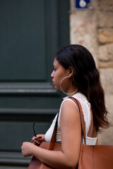 young latin american woman walking through the streets of the city of lyon france