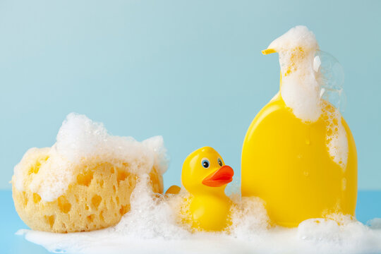 Baby shampoo  on a white  background, rubber yellow ducks, soap foam. Bathroom accessories