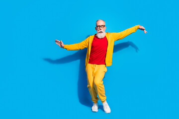 Full size photo of crazy funky funny silly grandfather dancing having fun fooling around isolated on blue color background