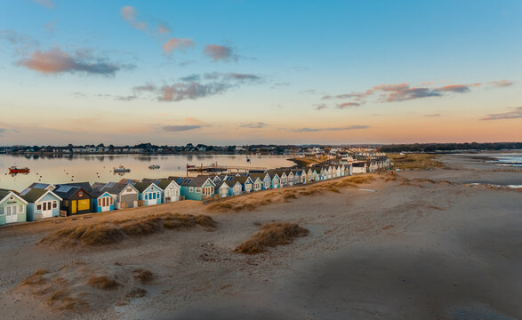 Aerial view of colourful houses in a row along the beach in Beach huts, Mudeford, Christchurch, Dorset, United Kingdom.