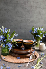 Cocoa in old cups on a table with blue flowers. Hot chocolate drinks. Flat lay.