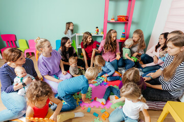 Lovely babies and their mothers at the nursery or daycare