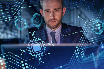 Handsome businessman in suit at workplace working with laptop to optimize development by implying...