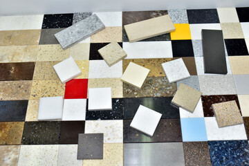 Samples of acrylic artificial stone for countertops. Artificial stone for interior decoration in the construction in houses. Quartz agglomerate or quartz agglomerate. Multicolored tiles
