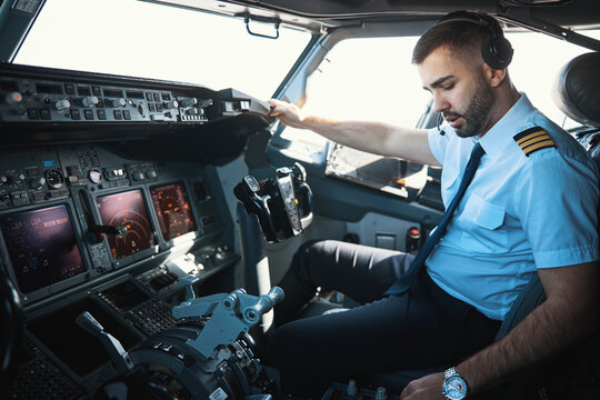 Handsome Caucasian pilot getting ready for the journey