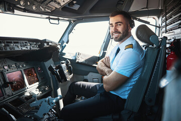 Contented pilot looking forward to the upcoming flight - obrazy, fototapety, plakaty