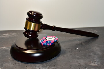 Judge hammer and poker chip for casino game. Justice courtroom. Concept of a court decision in a...