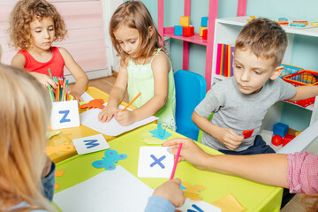 Preschool children learn english alphabet using cards