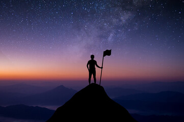 Silhouette of businessman standing on top of the mountain over the sky and star, Milky way with flag. He was delighted and showed the achievement of his goals in his work.