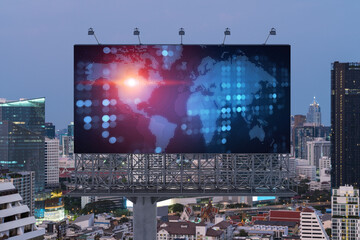Glowing hologram of Earth planet map on billboard over aerial panoramic cityscape of Bangkok at sunset. The concept of international business in Southeast Asia.