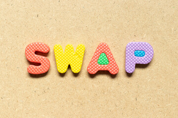 Foam alphabet letter in word swap on wood background