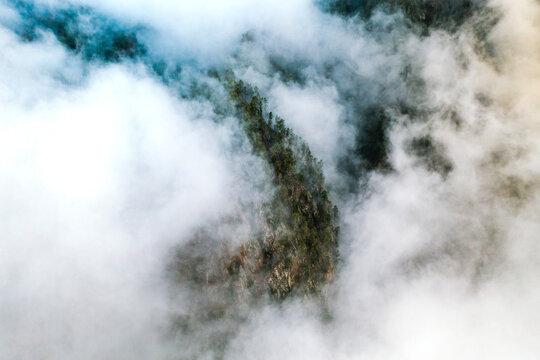 Aerial view of mountain rock covered with clouds in La Palma near El Paso, Canary islands, Spain.