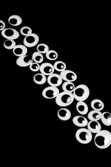 Line laid out from toy eyes on black background
