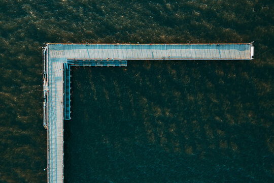 Aerial view of L-form pedestrian bridge in Baltic sea near Palanga, Lithuania.