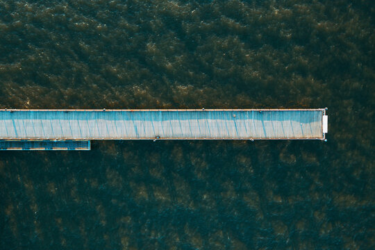Aerial view of straight line shape pedestrian bridge in Baltic sea near Palanga, Lithuania.