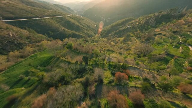 Fast Cinematic Drone Dive in Beautiful Mountain Village Above the Hills with Terraces lit with Evening sun During Sunset in Turkey, Pamphyila Region. Aerial freestyle aerobatic View Shot on FPV racing
