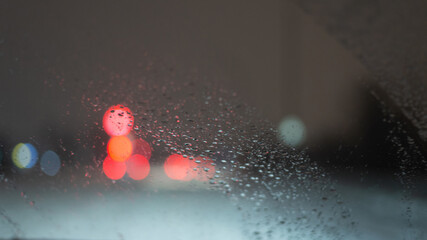 Blurred background with raindrops and lights.