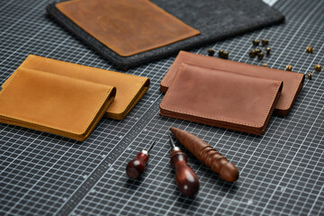 Handmade products made of genuine yellow and red leather. Leather passport cover, leather wallet. Leather goods for men. The view from the top