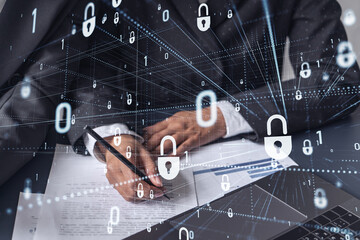 Two businesswomen working on the project to protect cyber security of international company. Padlock Hologram icons over the table with documents.