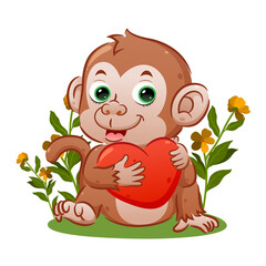 The cute monkey with the happy face is sitting and holding the big heart