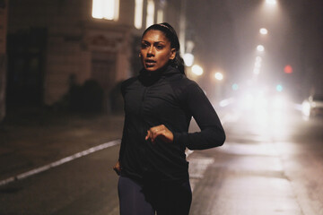 Woman running at night in the city