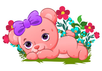 The cute bear lie down her body on the grass in the garden full of flowers