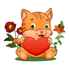 The cute kitten is holding a big heart on his hands in the flowers park
