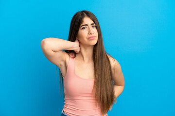 Young caucasian woman isolated on blue background with neckache