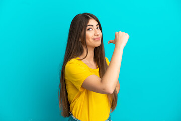 Fototapeta premium Young caucasian woman isolated on blue background proud and self-satisfied