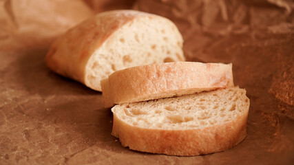 Ciabatta slices on craft paper. Fresh delicious pastries. Fresh homemade bread.