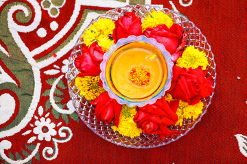 Fototapeta na wymiar Traditional wedding ceremony in Hinduism: Turmeric in plate for haldi ceremony