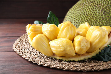 Fresh exotic jackfruit bulbs on wooden table