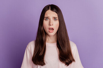 Portrait of speechless beautiful woman open mouth look camera on purple wall