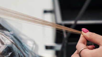 Hairstylist dyeing woman hair at beauty salon. Airtouch color technique. Closeup