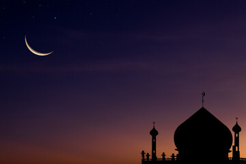 Crescent moon on dusk twilight sky over silhouette dome mosques, symbols of religious Islamic Ramadan month