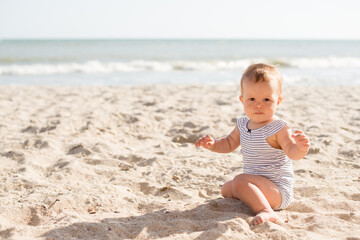 Small girl sitting on sand at beach