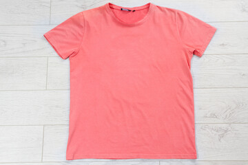 pink t shirt mock up on wooden background top view, red T-shirt background