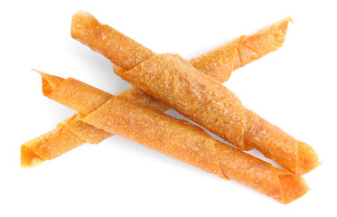 Delicious fruit leather rolls on white background, top view