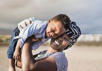 African mother and little son having playful time outdoor - Family, mother and toddler love