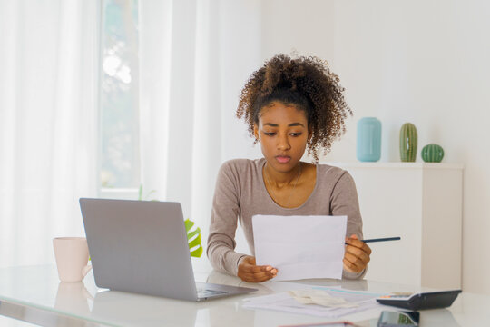 Unhappy black woman feel stressed working on computer at home