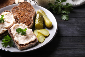 Fototapeta na wymiar Delicious sandwiches with lard spread on black wooden table, closeup