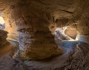 Natural tunnels and grottoes in the red valley of Cappadocia Turkey with the road inside