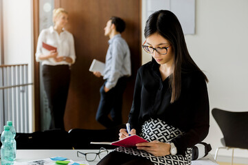Germany, Bavaria, Munich, Male and female students waiting in corridor