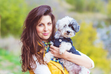 Beautiful Young Woman Hugging  Her White Havanese  Dog Outdoor in the Mountain .Pet and Owner Outdoor 