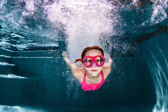 Girl diving in swimming pool