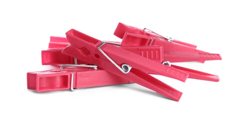 Bright pink plastic clothespins on white background