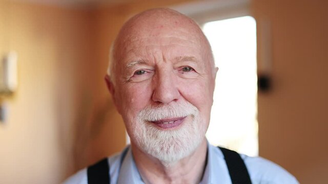 Happy senior man looking at camera and smiling
