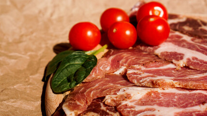 Meat slices and cherry tomatoes. Ingredients for sandwich and bruschetta