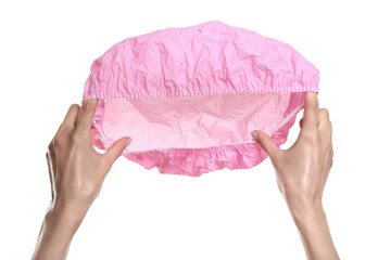 Woman holding pink shower cap on white background, closeup