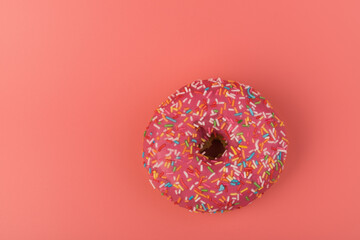 Fresh made Donuts isolated on pink background. Doughnuts are traditional sweet pastries. Copy space for text.